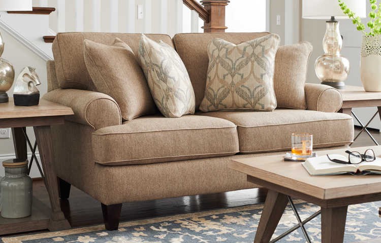 an image featuring a beige colored sofa with a table