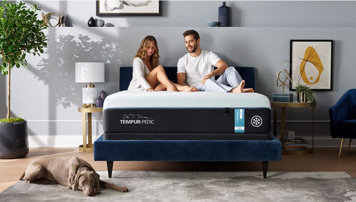 Couple sitting on a Tempur-LuxeAdapt breeze&deg; mattress